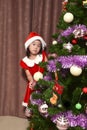 Portrait of a little Asian girl wearing Santa Claus costume with christmas tree Royalty Free Stock Photo