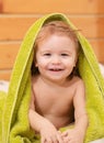 Portrait of little baby boy cover body under towel after bath. Concept of kids face close-up. Head shoot children