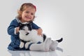 Portrait of Little baby girl holding her fluffy cat on white background