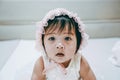 Portrait of Little baby girl wear white hood. Child with white theme suit. Royalty Free Stock Photo