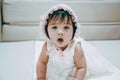 Portrait of Little baby girl wear white hood. Child with white theme suit. Royalty Free Stock Photo