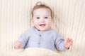 Portrait of a little baby under a warm knitted blanket Royalty Free Stock Photo