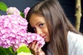 Portrait of a little beautiful girl with a bouquet of hydrangeas in her hands. Royalty Free Stock Photo