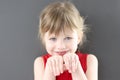 Portrait of little beautiful smiling girl with hands in front of her face Royalty Free Stock Photo