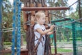 Portrait of a little blond girl in rope park. Royalty Free Stock Photo