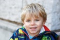 Portrait of little blond toddler boy smiling outdoors Royalty Free Stock Photo