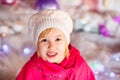 Portrait of little blonde smiling girl with white beret, red boots, pink cloak. Christmas and New Year theme Royalty Free Stock Photo