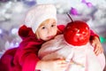 Portrait of little blonde smiling girl with white beret, red boots, pink cloak and huge artificial cake. Christmas and New Year Royalty Free Stock Photo