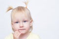 Portrait of a little blue-eyed blonde girl on a white background, close-up, looking at the camera, copy space, caucasian Royalty Free Stock Photo