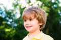 Portrait of little boy. Concept of kids face close-up. Head shoot children portrait in summer nature park.