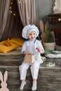 Portrait of a little boy cook at kitchen. Different occupations. Isolated over white background Royalty Free Stock Photo