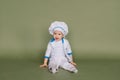 Portrait of a little boy cook at kitchen. Different occupations. Isolated over white background Royalty Free Stock Photo