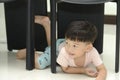 Little boy crawling under the chair.Playful time