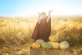 Portrait of a little boy dressed as a dracula outdoors in a pumpkin patch on sunset background. Happy halloween.