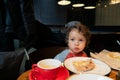 Portrait of a little boy eating pizza in a cafe Royalty Free Stock Photo