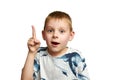 Portrait of a little boy excited with an idea. A boy holds his index finger up isolated on a white background Royalty Free Stock Photo