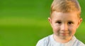 Portrait of little boy on green grass field Royalty Free Stock Photo