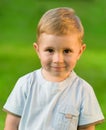 Portrait of little boy on green grass field Royalty Free Stock Photo