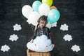 Portrait of the little boy in the pilot`s suit. Flight in the balloon. A cloud - pillow in hands at the boy Royalty Free Stock Photo