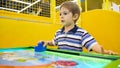 Portrait of little boy playing in air hockey at amusement park Royalty Free Stock Photo