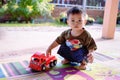 Portrait of a little boy playing car toy and looking at the camera. Royalty Free Stock Photo