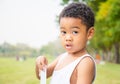 Portrait of little boy playing outdoors in a park and looking at camera, Kids concept Royalty Free Stock Photo