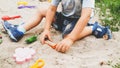 Portrait of little toddler boy playing with toys and sand on th eplayground Royalty Free Stock Photo