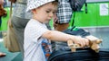 Portrait of little boy playing with wooden toy airplane in modern airport terminal Royalty Free Stock Photo