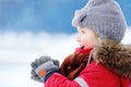 Portrait of little boy in red winter clothes having fun with snow Royalty Free Stock Photo