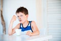 Portrait of little boy refuses to eat delicious yogurt Royalty Free Stock Photo