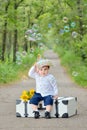 Portrait of a little boy with s suitcase