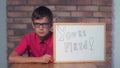 Child sitting at the desk holding flipchart with lettering fired