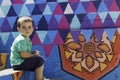 Portrait of little boy sitting on the steps and colorful wall Royalty Free Stock Photo