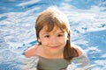 Portrait of little boy swim in sea. Kid laughing in water of waves at sea. Funny kids face. Royalty Free Stock Photo