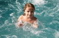 Portrait of little boy swim in sea. Kid laughing in water of waves at sea. Funny kids face. Royalty Free Stock Photo