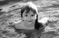 Portrait of little boy swim in sea. Kid laughing in water of waves at sea. Funny kids face. Royalty Free Stock Photo