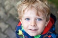 Portrait of little boy two years old on rainy day