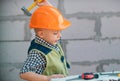 Portrait of little builder in hardhats with instruments for renovation on construction. Builder boy, carpenter kid with Royalty Free Stock Photo