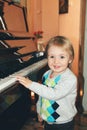 Portrait of little caucasian boy playing piano at home Royalty Free Stock Photo