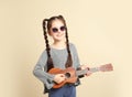 Portrait of little cheerful girl playing guitar Royalty Free Stock Photo