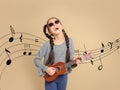 Portrait of little cheerful girl playing guitar Royalty Free Stock Photo