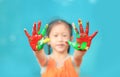 Portrait of little cheerful girl showing her colorful hands painted. Focus at baby hands Royalty Free Stock Photo