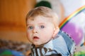 Portrait of little child, cute adorable baby boy playing with colorful toys. Happy, curious kid at home, indoors. Royalty Free Stock Photo