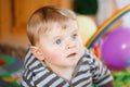 Portrait of little child, cute adorable baby boy playing with colorful toys. Happy, curious kid at home, indoors. Royalty Free Stock Photo