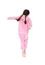 Portrait of little child girl in pink tracksuit or sport cloth jumping on air over white background. Freedom kid movement concept Royalty Free Stock Photo
