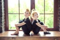 Portrait of 2 little children dancer girl and boy in black leotard sitting on window at dance studio. Recovery on dancing lesson. Royalty Free Stock Photo