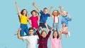 Portrait of little children jumping isolated on blue studio background with copyspace Royalty Free Stock Photo