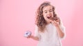 Portrait of a little curly girl eating donuts Royalty Free Stock Photo