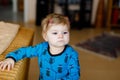 Portrait of little cute baby girl learning walking and standing. Adorable toddler girl at home. Beautiful baby child in Royalty Free Stock Photo