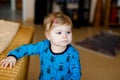 Portrait of little cute baby girl learning walking and standing. Adorable toddler girl at home. Beautiful baby child in Royalty Free Stock Photo